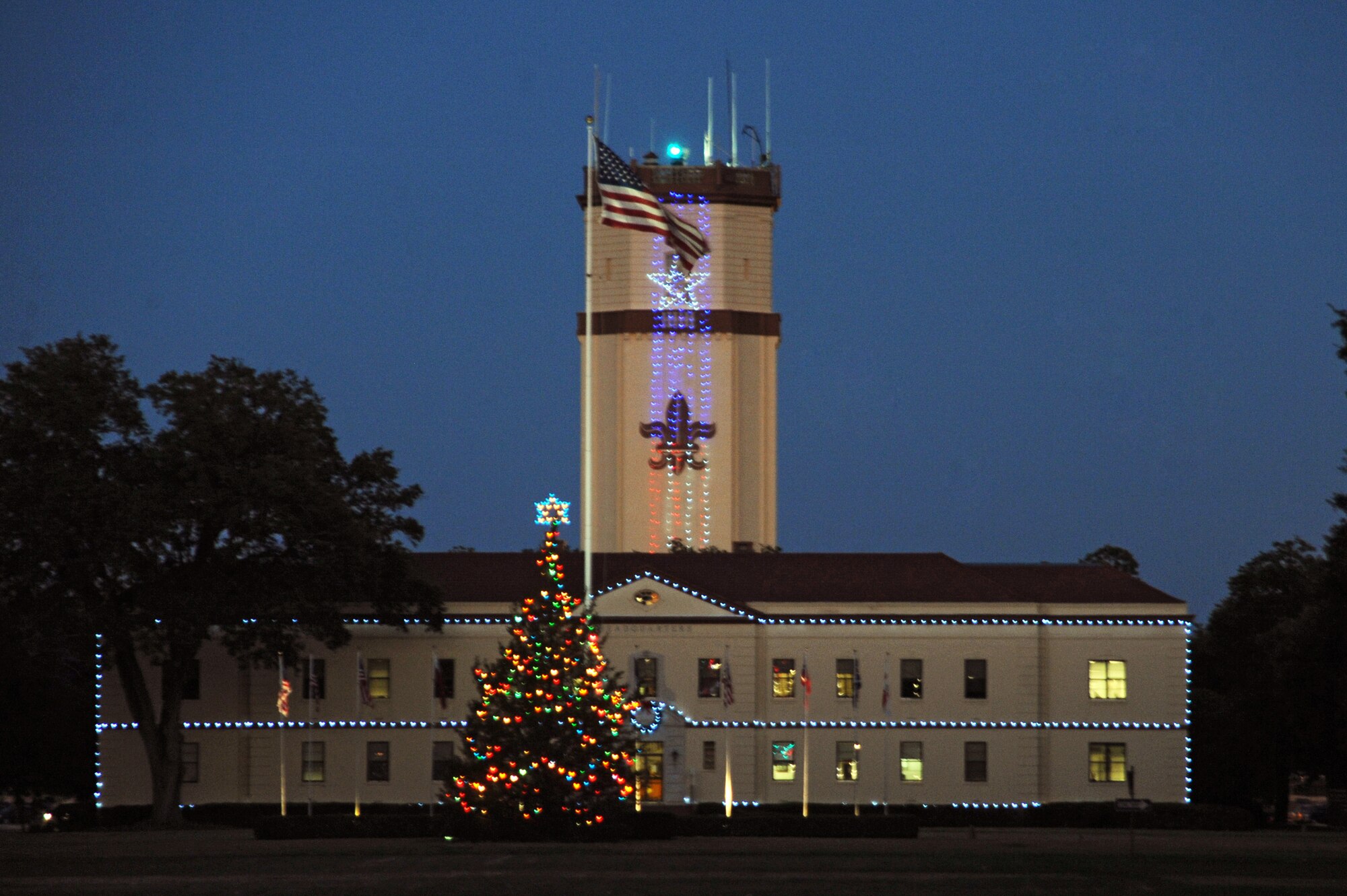 Festive lights of the 2nd Bomb Wing Headquarters and base Christmas tree welcome Airmen and visitors to barksdale. The Christmas tree lighting ceremony was held at Chapel 1 on Barksdale Air Force Base, La., Nov. 30. (U.S. Air Force photo/Senior Airman Brittany Y. Bateman)(RELEASED)