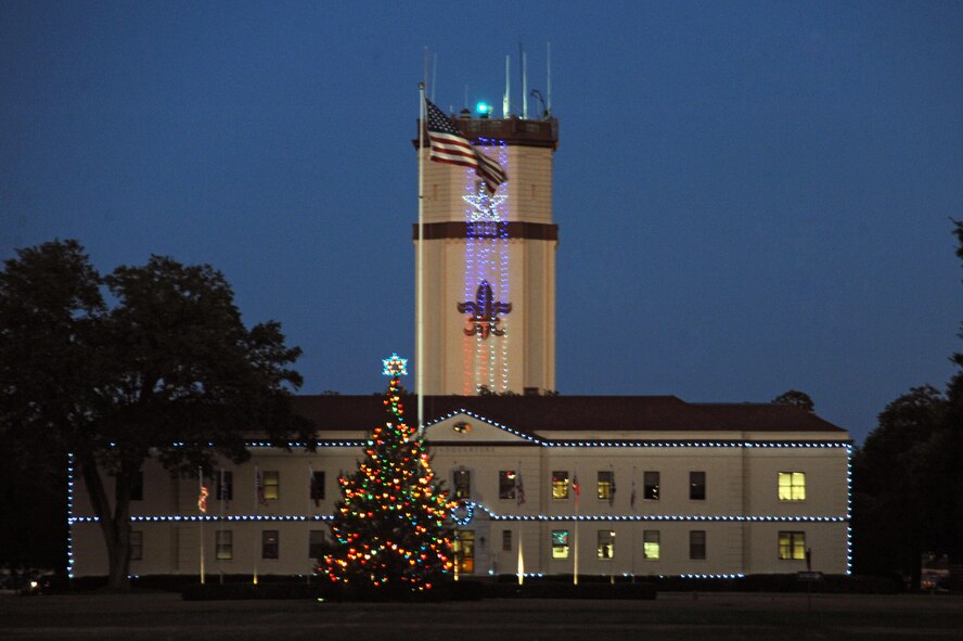 Festive lights of the 2nd Bomb Wing Headquarters and base Christmas tree welcome Airmen and visitors to barksdale. The Christmas tree lighting ceremony was held at Chapel 1 on Barksdale Air Force Base, La., Nov. 30. (U.S. Air Force photo/Senior Airman Brittany Y. Bateman)(RELEASED)