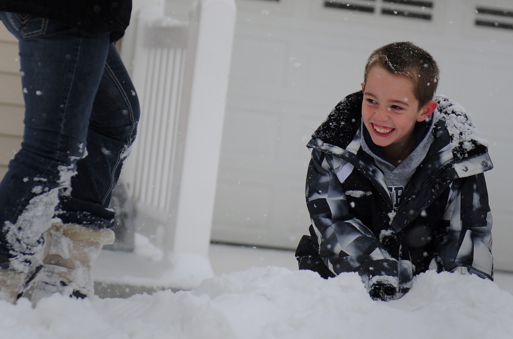MOUNTAIN HOME AIR FORCE BASE, Idaho -- Nine-year-old Cody Alvarado, son of Tech Sgt. Christopher Alvarado, 366th Component Maintenance Squadron, plays in the snow in base housing Dec. 1. The base and local schools were closed due the inclement weather. (U.S. Air Force photo by Staff Sgt. Gina Chiaverotti-Paige) 
