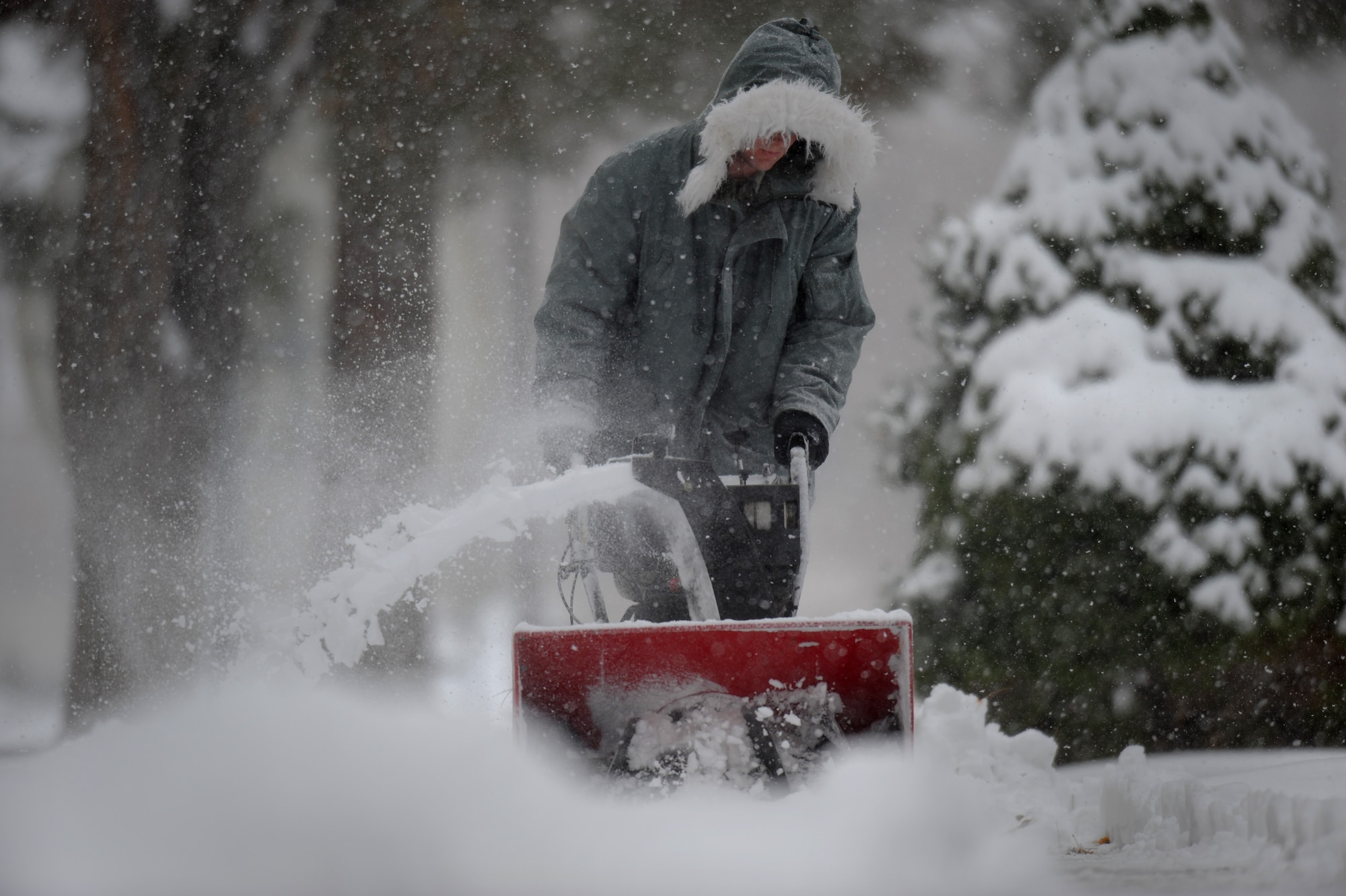 MOUNTAIN HOME AIR FORCE BASE, Idaho -- Airman 1st Class Peter Logar, 366th Operations Support Squadron air traffic controller, uses a snow blower to remove snow from sidewalks around the Airmen dormitories Dec. 1.  The base received over three inches of snow in the last 12 hours. (U.S. Air Force photo by Staff Sgt. Gina Chiaverotti-Paige)