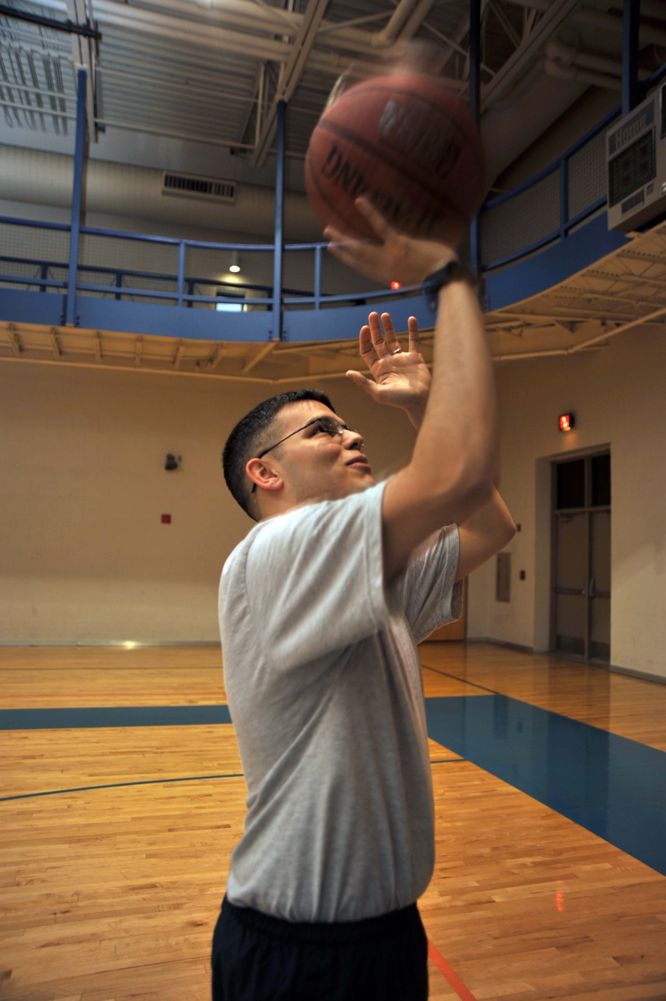 Senior Airman Tres Taylor shoots hoops as part of his daily workout at the base fitness center, McConnell Air Force Base, Kan.  Airman Taylor recently improved his physical fitness test score by more than 60 points.  (U.S. Air Force photo/Senior Airman Abigail Klein)