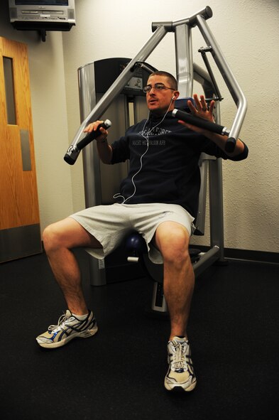 MINOT AIR FORCE BASE N.D. -- 1st Lt. Justin Shetter, 5th Aircraft Maintenance aircraft maintenance unit officer in charge, weight trains at the McAdoo Fitness Center here Dec. 1. Exercising is a great way to fight weight gain during the cold weather season. (U.S. Air Force photo/Airman 1st Class Aaron-Forrest Wainwright)
