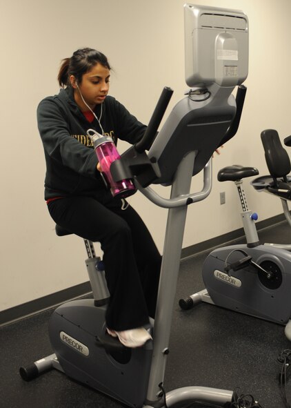 MINOT AIR FORCE BASE N.D. -- Payal Mehta, 5th Force Support Squadron youth management trainee uses a stationary bike at the McAdoo Fitness Center here Dec. 1. Exercise is one of the keys ways to fight weight gain during the cold weather season. (U.S. Air Force photo/Airman 1st Class Aaron-Forrest Wainwright)
