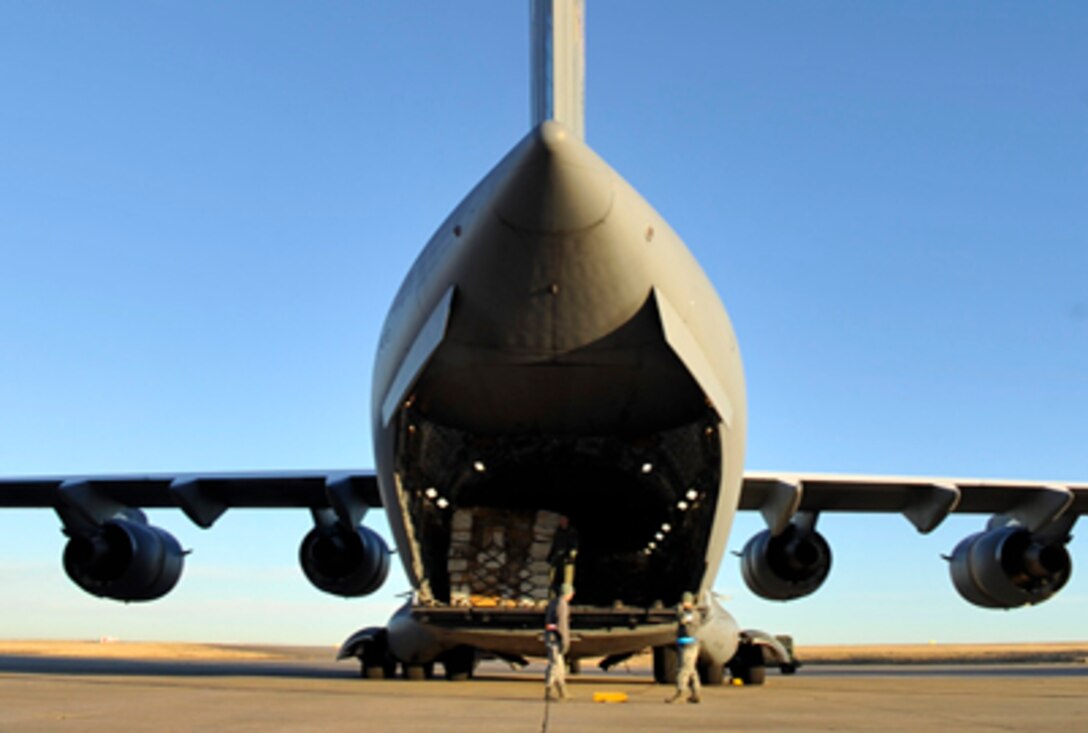 A C-17 Globemaster III sits on the flightline recently at Buckley Air Force Base, Colo., while being loaded with pallets containing supplies bound for Afghanistan. Planners hope the supplies will allow for the refurbishing and/or rebuilding of 25 hospitals and clinics in the region. (U.S. Air Force photo/Airman 1st Class Paul Labbe)