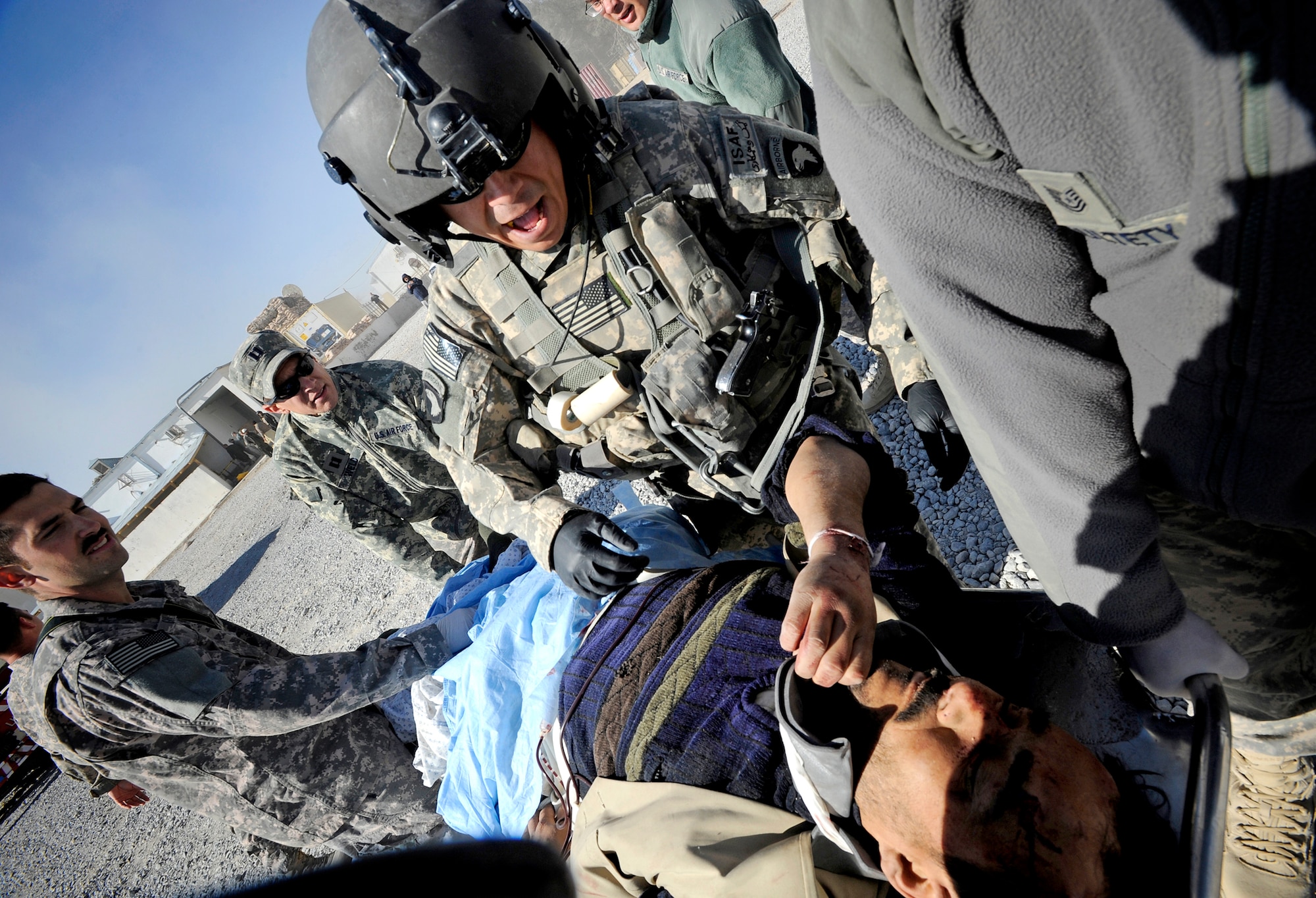 A flight medic assesses a patient before loading him onto a medevac helicopter, Nov. 30, 2010, at Forward Operating Base Smart, Afghanistan. (U.S. Air Force photo/Staff Sgt. Brian Ferguson) 
