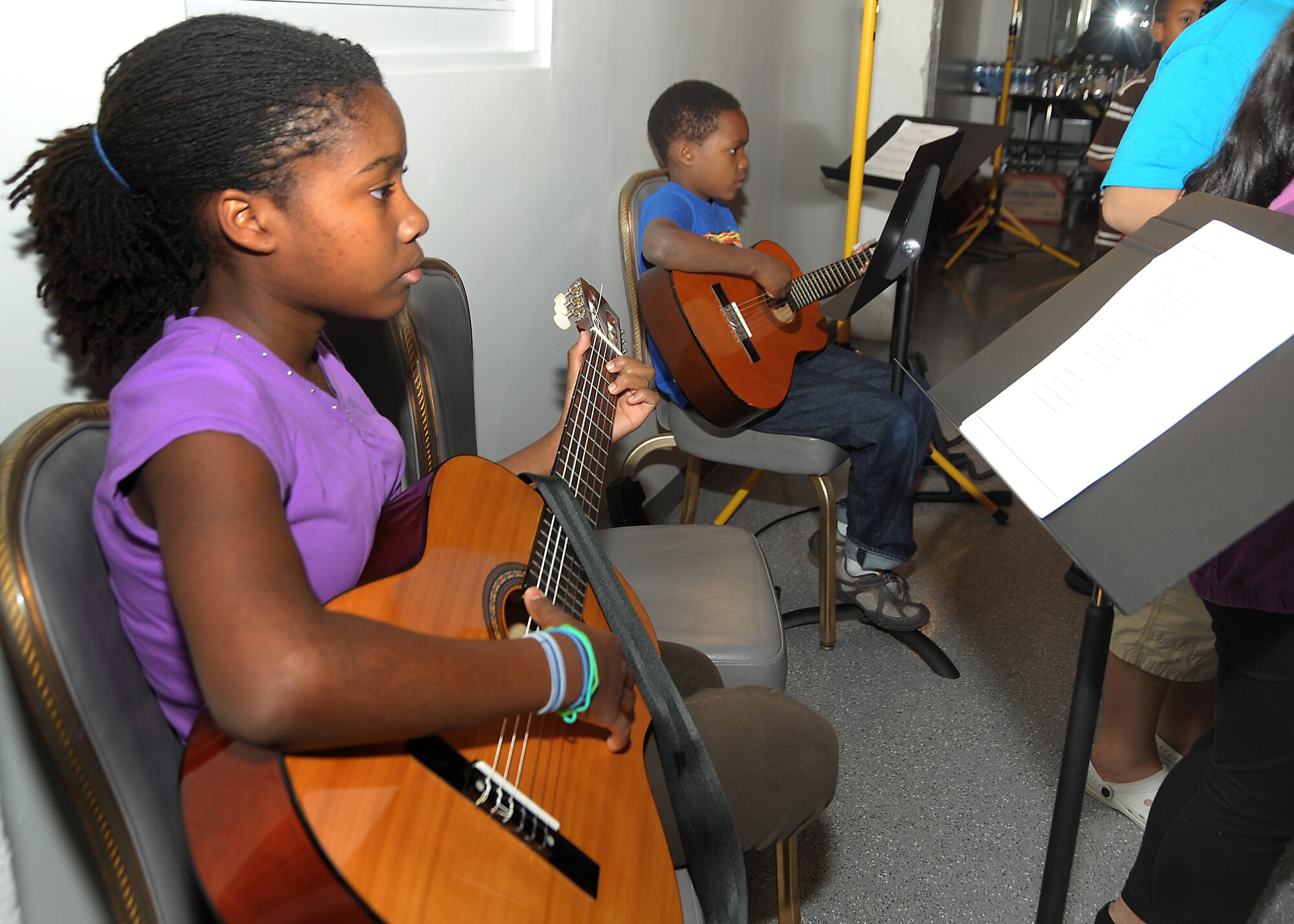 Danielle and Elijah Devine perform a tune on guitar for the parents at the Family Feast Pot Luck, Nov. 18.  Los Angeles Air Force Base, 61st Force Support Squadron and Youth Programs Office hosted the event to kick off the Thanksgiving holiday and provided ham and turkey to the many side dishes brought by family members. (Photo by Joe Juarez)