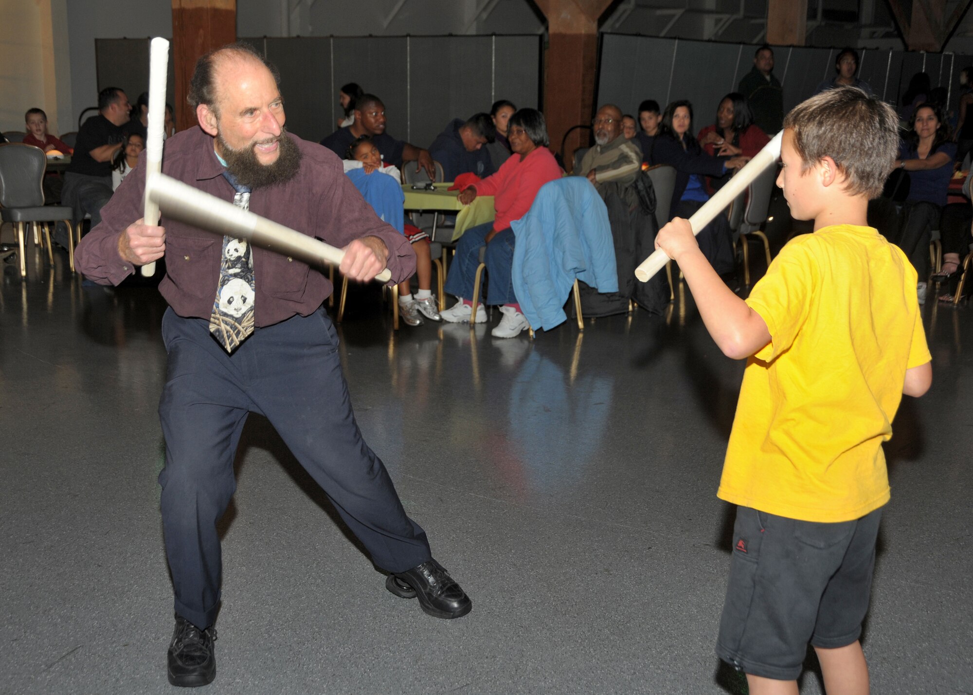 Karate instructor “Sensei” Gerome Ginsburg spares with student Carson Rohan at the Family Feast Pot Luck, Nov. 18.  Los Angeles Air Force Base, 61st Force Support Squadron and Youth Programs Office hosted the event to kick off the Thanksgiving holiday and provided ham and turkey to the many side dishes brought by family members. (Photo by Joe Juarez)
