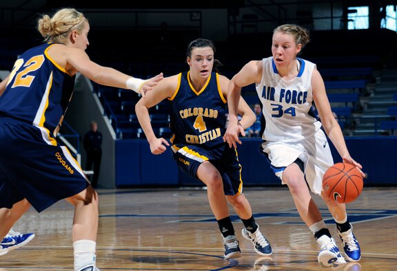 Air Force sophomore forward Kelsey Berger drives past Colorado Christian's Christina Whitelaw during the Falcons' match against the Tigers at the Air Force Academy's Clune Arena Nov. 28, 2010. Berger, a native of Mentor, Ohio, scored eight points in the Falcons' 68-58 win. (U.S. Air Force photo/Megan Davis)
