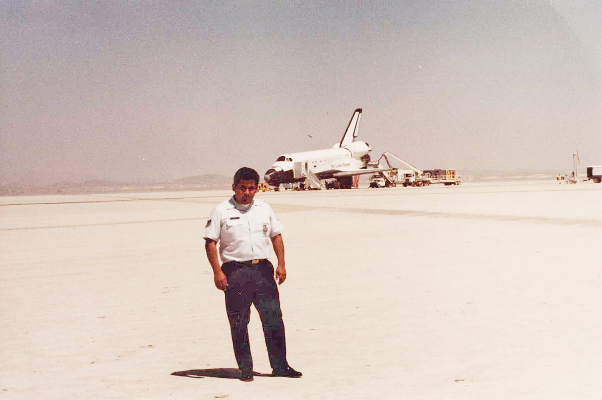 Chief Joe Ybarra, 95th Air Base Wing Fire Department, stands in front of Space Shuttle Colombia after its first landing at Edwards, Apr. 14, 1981. Chief Ybarra was present for 45 of the total landings on base and was responsible for developing emergency procedures for the shuttle landings. (Courtesy photo) 