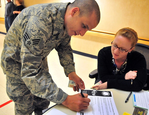 Senior Airman Marcus Maltese steps up for the Great American Smokeout pledge at the 628th Medical Group Clinic on Joint Base Charleston, S.C., Nov. 18, 2010. Combating the use of cancer causing tobacco products is the goal of the Great American Smokeout. It serves to spur active users to drop the habit for a full 24 hours, while providing information on treatment and support networks to aid in quitting for good. The Smokeout information booth at the Clinic was manned by Health and Wellness Center Dietician Greer Gowen. She and members of the HAWC staff provides a full spectrum of healthy living classes for the base, including those for tobacco cessation. (U.S. Air Force photo/Staff Sgt. Daniel Bowles)
