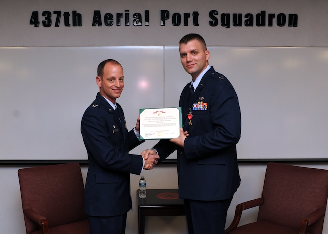 Capt. Nicholas Lee, right, is awarded the Bronze Star by Col. James Clavenna at the 437th Aerial Port Squadron on Joint Base Charleston, S.C., Nov. 22, 2010, for his meritorious service while deployed in a combat zone in support of Operation Enduring Freedom while assigned to the 1st Brigade, 201st Corps, in Afghanistan from May 7, 2009, to May 6, 2010. Captain Lee distinguished himself by serving in several key positions and personally commanding more than 70 mounted combat patrols covering 1,500 miles of contested Afghan terrain across nine provinces. His exploits included leading two Air Assault missions to set polling sites in a known Taliban safe haven, effectively securing more than 1,200 Afghan votes; planning and execution of three humanitarian aid missions, delivering 30,000 pounds of aid valued at $125,000; and command of a Mobile Response Force for three classified prisoner transfer missions. Colonel Clavenna is the 437th Maintenance Group commander, and Captain Lee is the 437th Aerial Port Squadron Cargo Flight commander. (U.S. Air Force photo/Senior Airman Timothy Taylor)