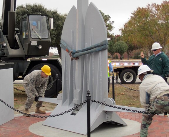 Members of the 628th Civil Engineer Squadron and Logistics Readiness Squadron move an anchor into position in front of Building 16000 on Joint Base Charleston, S.C., Nov. 29, 2010. The anchor, along with the accompanying C-17 static display, symbolizes the creation of Joint Base Charleston. SABER, or Simplified Acquisition of Base Engineer Requirements, executed the project, and Senior Airman Ryan Nolan, assigned to the 628 CES, was the project manager. (U.S. Air Force photo/1st Lt. Suzanne Jumper)