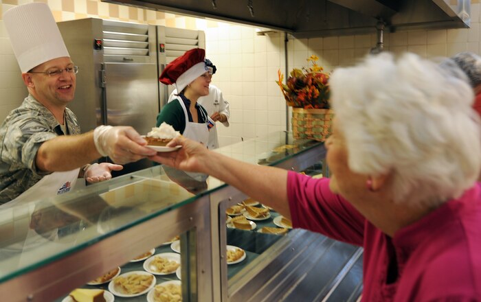 Senior Master Sgt. Gerard Komen serves Thanksgiving dinner at the Robert D. Gaylor Dining Facility on Joint Base Charleston, S.C., Nov. 25, 2010. A traditional Thanksgiving dinner with turkey, ham and all the fixings were served to active-duty military, retirees and their families. Sergeant Komen is with the 437th Maintenance Operations Squadron. (U.S. Air Force photo/Tech. Sgt  Chrissy Best)