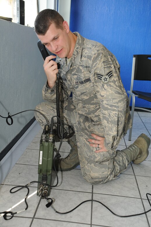 GUATEMALA CITY, Guatemala --  Senior Airman Henry Tolson, who works with the J6 communications office at Soto Cano Air Base, Honduras, conducts a radio communications check with the forward deployed command post during a medical readiness training exercise here Nov. 30. Mission communications involves more than radios, though; servicemembers use computers, radios, phones and more to ensure a constant flow of timely information. On medical missions, communications is also necessary to ensure a quick response to medical evacuation requests. (U.S. Air Force photo/Tech. Sgt. Benjamin Rojek)