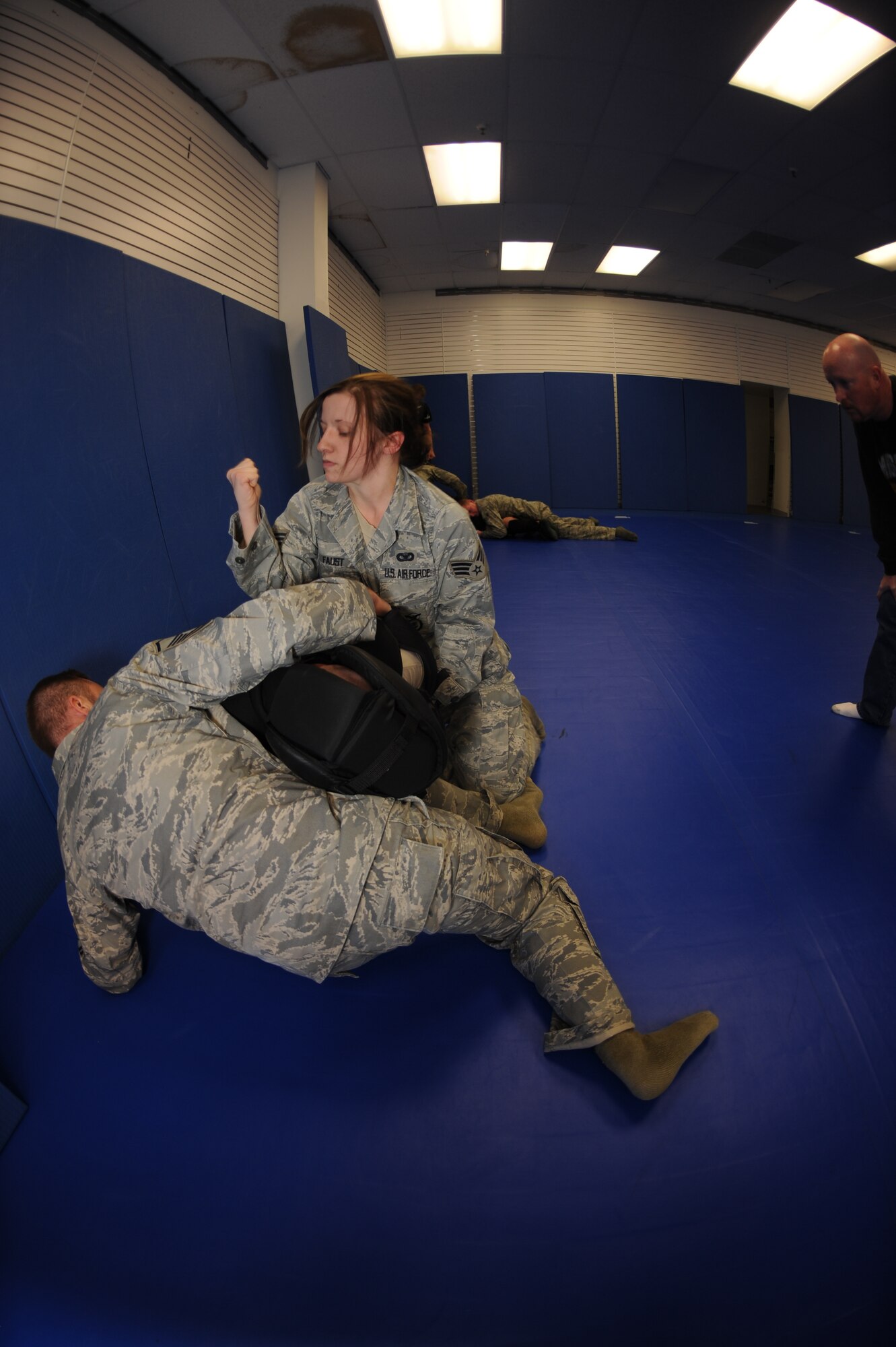 MINOT AIR FORCE BASE, N.D. -- Senior Airman Hannah Faust, 91st Missile Security Forces Squadron, security forces member, practices non-lethal combative training with her wingmen here Nov. 23. Non-lethal combative training is used to detain unarmed trespassers on Air Force Global Strike Command property. (U.S. Air Force photo/Airman 1st Class Aaron-Forrest Wainwright)
