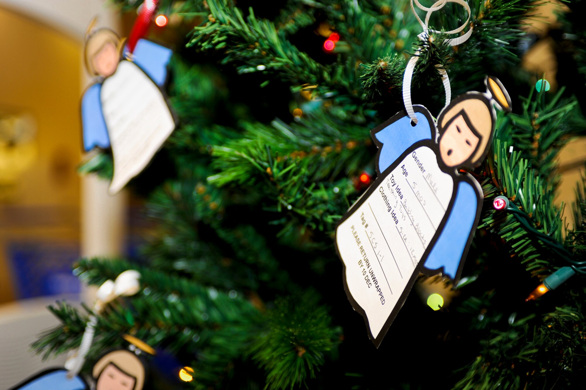 MINOT AIR FORCE BASE, N.D. -- Angels hang on the Christmas tree in the Exchange with holiday gift wishes from children of active duty members here Nov. 30. The angels on the tree are a significant part of Operation Angel Tree. (U.S. Air Force photo/Senior Airman Benjamin Stratton)