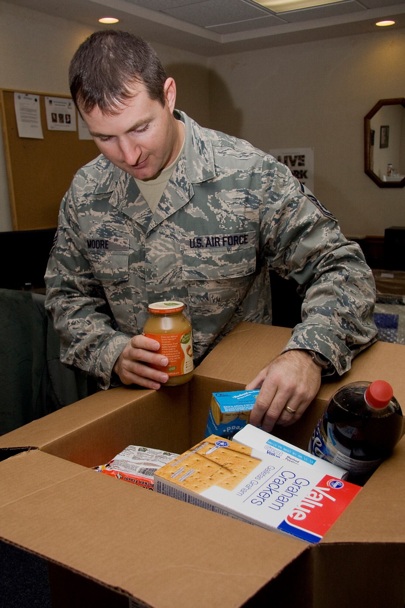 GRISSOM AIR RESERVE BASE, Ind. -- Master Sgt. Nathan Moore sorts through food donated to help those in need. The 434th Airman and Family Readiness office will be collecting food for a holiday food drive through Saturday of the December unit training assembly. Sergeant Moore is a noncommissioned officer in charge of the 434th A&FR office. (U.S. Air Force photo/Tech. Sgt. Mark R. W. Orders-Woempner)