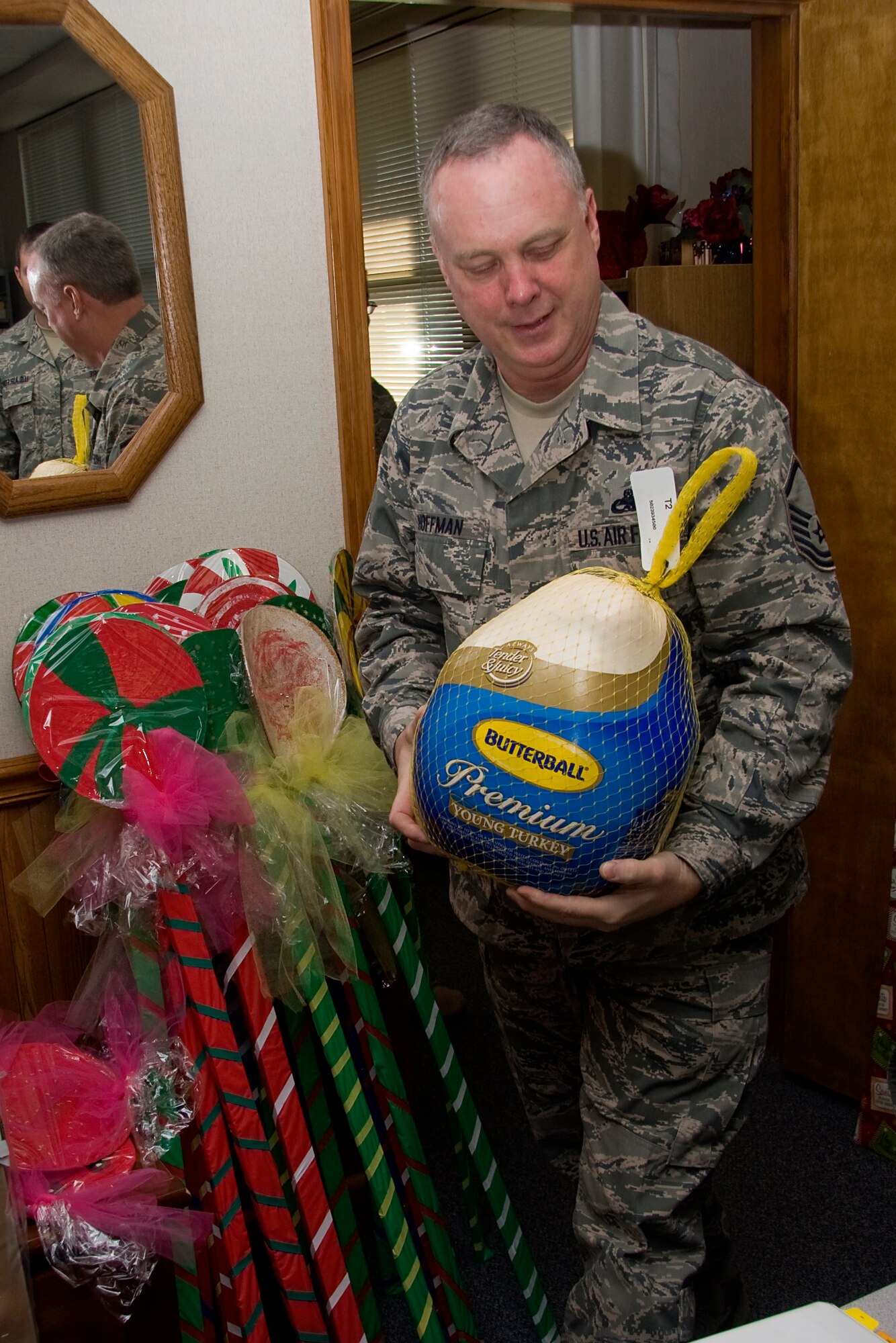 GRISSOM AIR RESERVE BASE, Ind. -- Master Sgt. Rob Hoffman carries in a turkey that was donated to help those in need. The 434th Airman and Family Readiness office will be collecting food for a holiday food drive through Saturday of the December unit training assembly. Sergeant Hoffman is a family readiness technician with the 434th A&FR office. (U.S. Air Force photo/Tech. Sgt. Mark R. W. Orders-Woempner)