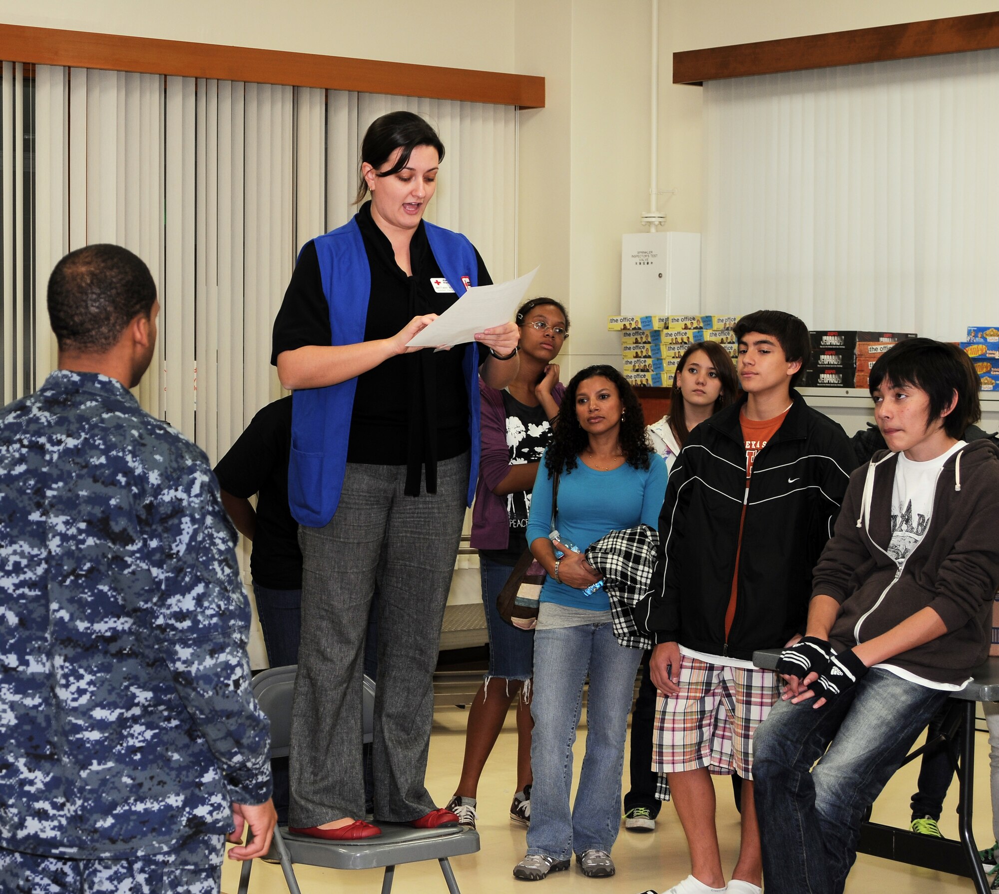 YOKOTA AIR BASE, Japan -- Brittany Reynolds, Yokota's American Red Cross assistant station manager and event coordinator, explains each of the four card sorting stations to volunteers during the Second Annual Holiday Mail for Heroes card sorting event, here November 29. More than 10,000 cards will be distributed across the base. (U.S. Air Force photo/ Airman 1st Class Katrina R. Menchaca)