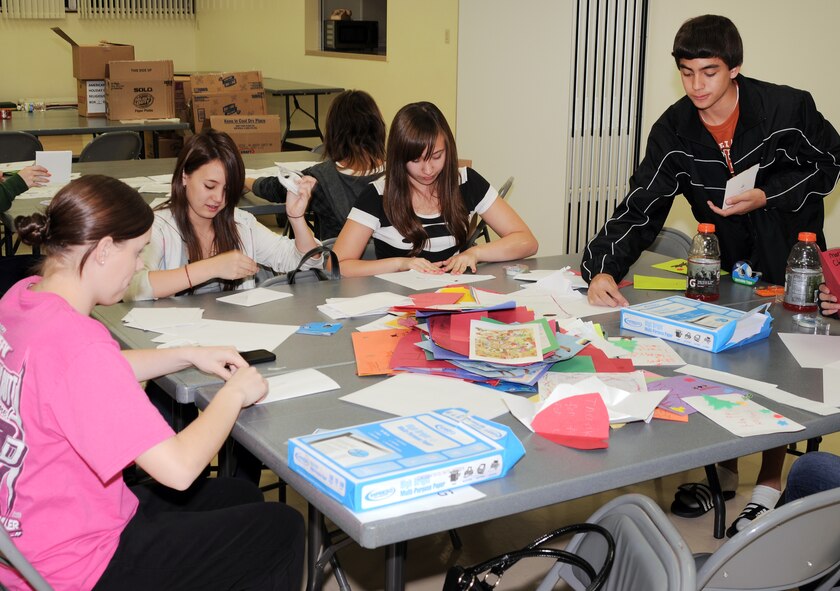 YOKOTA AIR BASE, Japan -- Students from Yokota Middle School's National Junior Honor Society, begin making envelopes for holiday cards during the Second Annual Holiday Mail for Heroes card sorting event, here November 29. More than 10,000 cards will be distributed across the base. (U.S. Air Force photo/ Airman 1st Class Katrina R. Menchaca)
