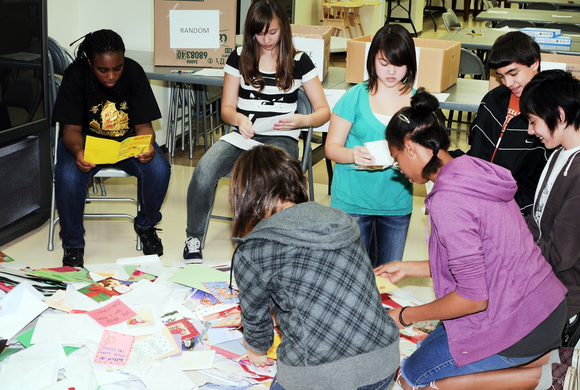 YOKOTA AIR BASE, Japan -- Students from Yokota Middle School's National Junior Honor Society, sort through thousands of holiday cards during the Second Annual Holiday Mail for Heroes card sorting event, here November 29. More than 10,000 cards will be distributed base wide. (U.S. Air Force photo/ Airman 1st Class Katrina R. Menchaca)