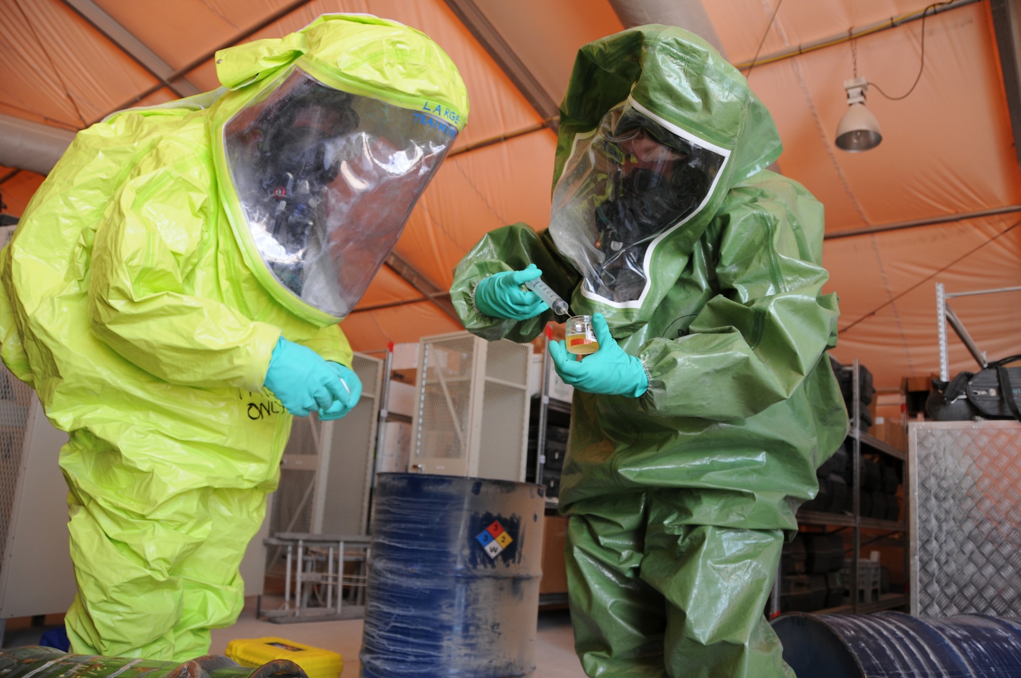 SOUTHWEST ASIA - Airman First Class Joshua Boze, left, and SrA Laura Lee, 379th Expeditionary Civil Engineer Squadron emergency managers,  collect the unknown agent, here Oct. 28, from simulated contamination scene during an interoperability exercise. (U.S. Air Force photo/Tech. Sgt. Kimberly Spinner)