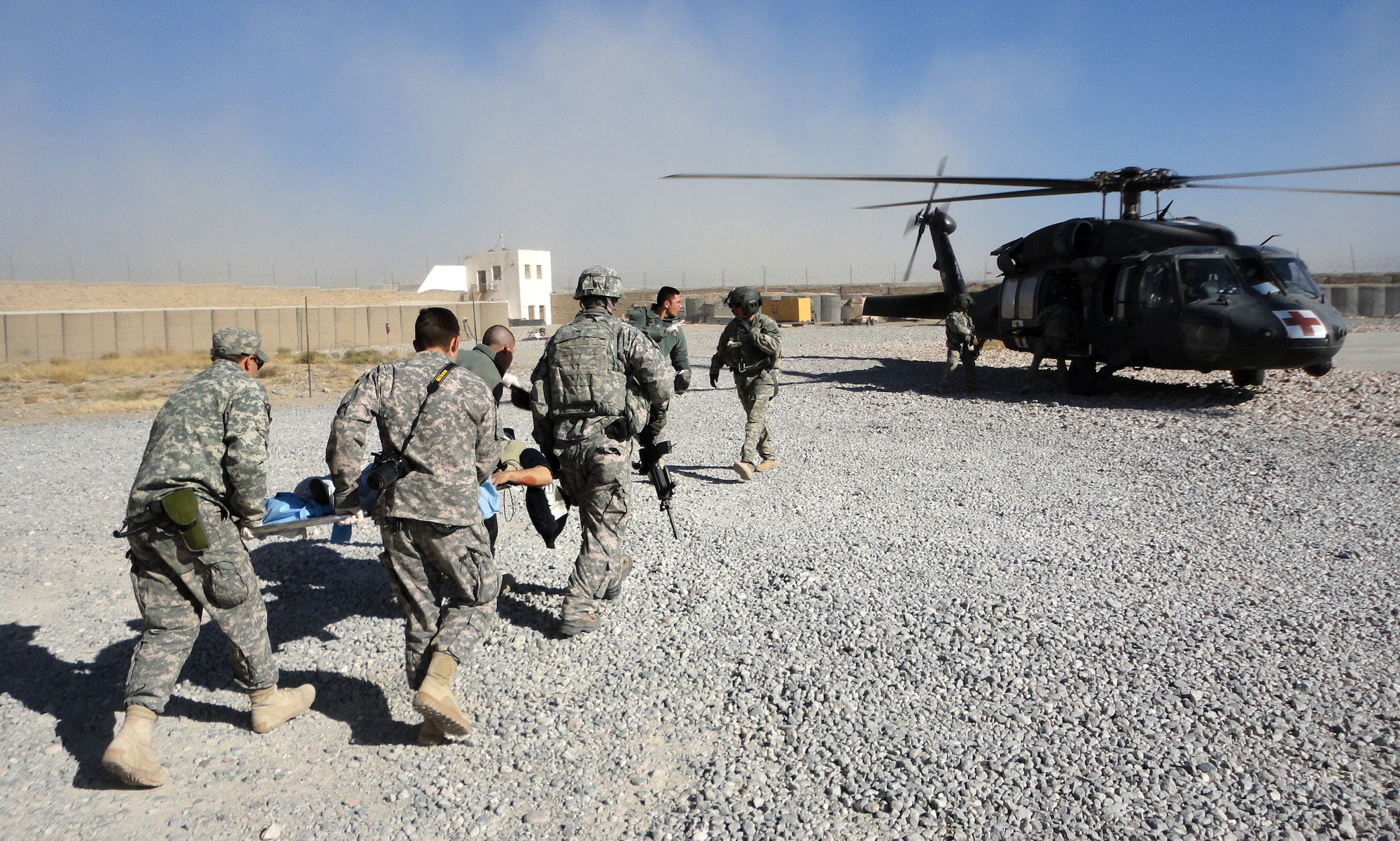 Airmen and soldiers from Provincial Reconstruction Team Zabul load a patient onto a medevac helicopter after a civilian bus headed south on Highway 1 rolled over leaving seven dead and more than 30 injured just outside Qalat City, Afghanistan, Nov. 30. Medical personnel from the PRT were on the scene at Zabul Provincial Hospital to assess patients and provide medical care. Nine patients with potentially life-threatening injuries were flown via helicopter from Forward Operating Base Smart to FOB Lagman, and then on to Kandahar. (U.S. Air Force photo by 1Lt. Brian Wagner/Released)


