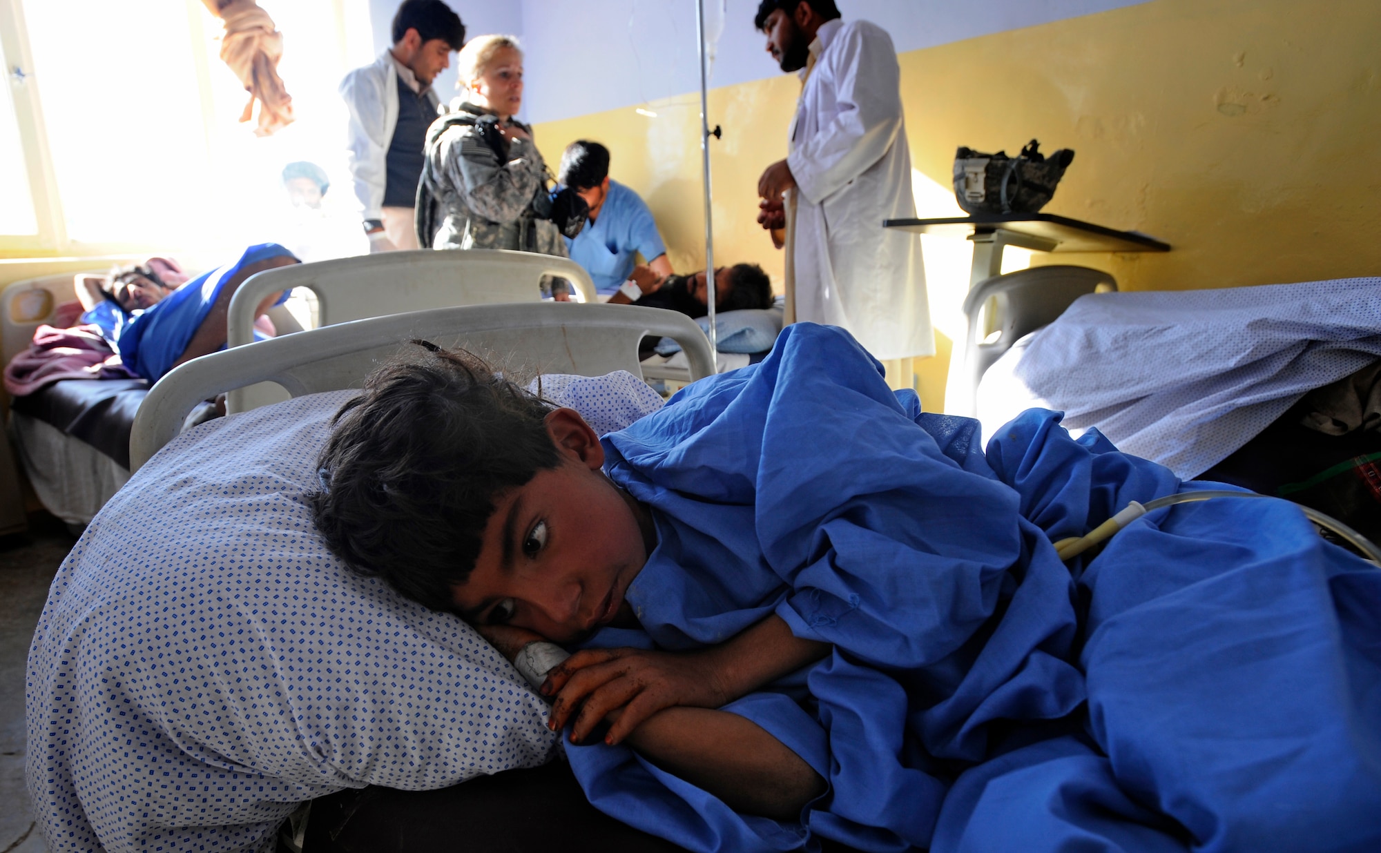 A young boy lies injured at the Zabul Provincial Hospital after a civilian bus headed south on Highway 1 rolled over leaving seven dead and more than 30 injured just outside Qalat City, Afghanistan, Nov. 30. Medical personnel from Provincial Reconstruction Team Zabul were on the scene at the hospital to assess patients and provide medical care. Nine patients with potentially life-threatening injuries were flown via helicopter from Forward Operating Base Smart to FOB Lagman, and then on to Kandahar. (U.S. Air Force photo by Staff Sgt. Brian Ferguson/Released)


