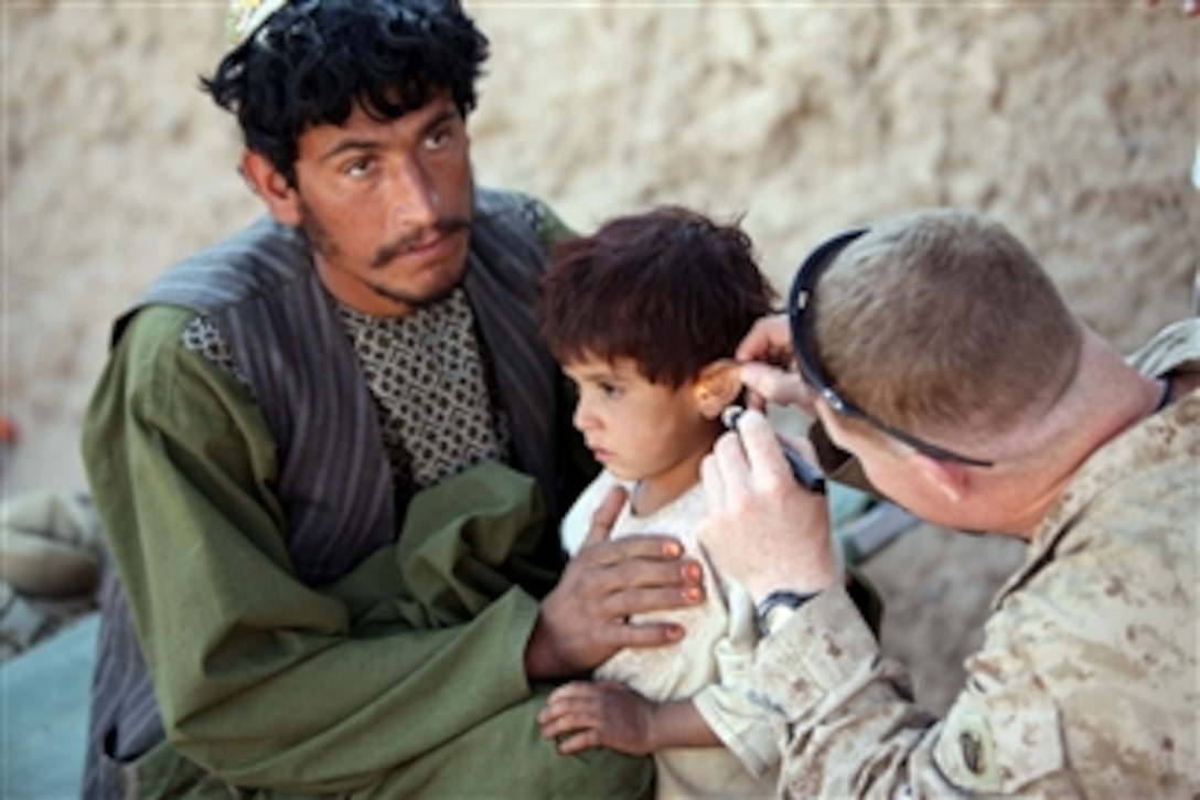 Chief Petty Officer David Worrell, the leading chief hospital corpsman for 3d Battalion, 25th Marine Regiment, treats an Afghan child during a village medical outreach project in Boldak, Afghanistan, on Nov. 22, 2010.  Afghanis were given care for minor injuries and illnesses and were also provided personal hygiene products such as toothbrushes and shampoo by members the International Security Assistance Force.  