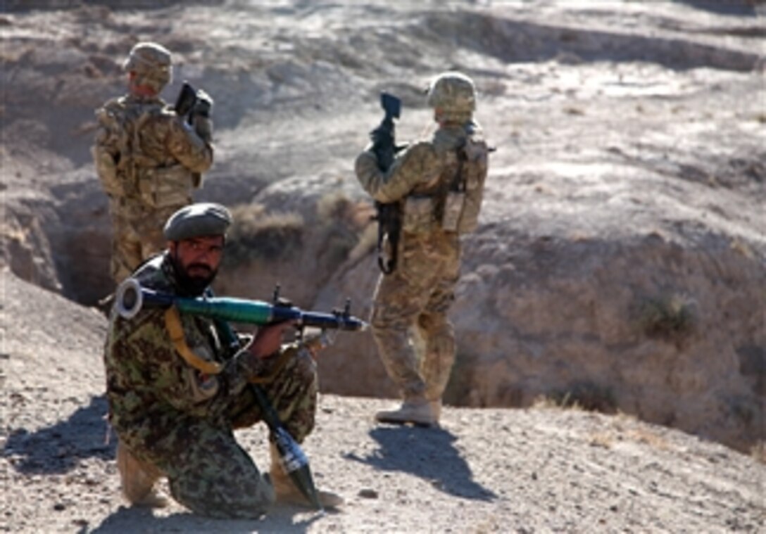 An Afghan National Army soldier (2nd from right) provides security with U.S Army soldiers from the 4th Brigade Combat Team, 10th Mountain Division in the Logar province of Afghanistan on Nov. 27, 2010.  