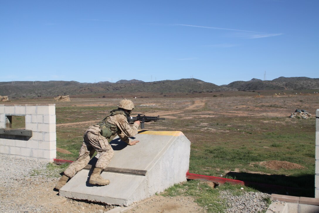 Recruit Christopher A. Wooley, Platoon 3226, Company K, fires at targets from a simulated bunker position. The recruits are instructed to properly fire behind cover as to not leave themselves open to return fire.