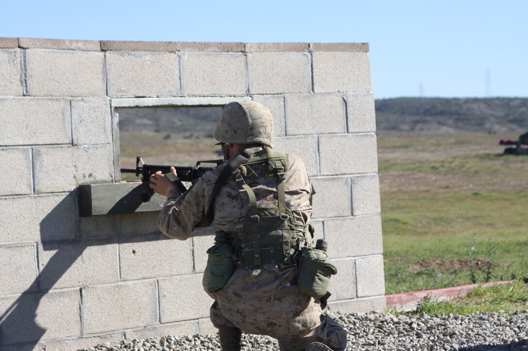 Recruit Lucas J. Tosh, Platoon 3226, Company K, fires from a simulated window position during the Crucible. The recruits are taught how to fire from a window while making sure that they do not leave themselves open to return fire.