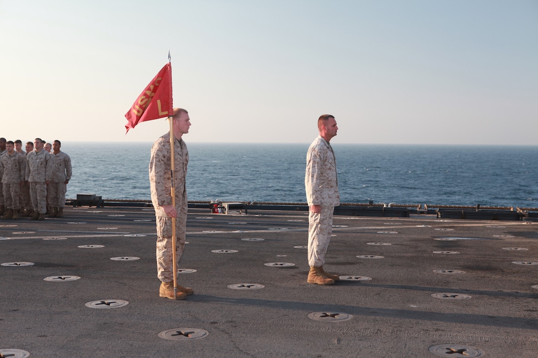 Gunnery Sergeant Issac D. Sweeton, Company L Co. Gunnery Sgt., and Cpl.Justin A. Heigold, a team leader with Weapons Company, Company L, Battalion Landing Team 3/8, 26th Marine Expeditionary Unit, stand at attention during a promotion ceremony held on the flight deck aboard USS Carter Hall, Dec. 2, 2010. 26th MEU is deployed aboard the ships of the Kearsarge Amphibious Ready Group in the 5th Fleet area of responsibility and acting as the theater reserve force. (Official USMC photo by Sgt. Jesse J. Johnson/ Released)::r::::n::