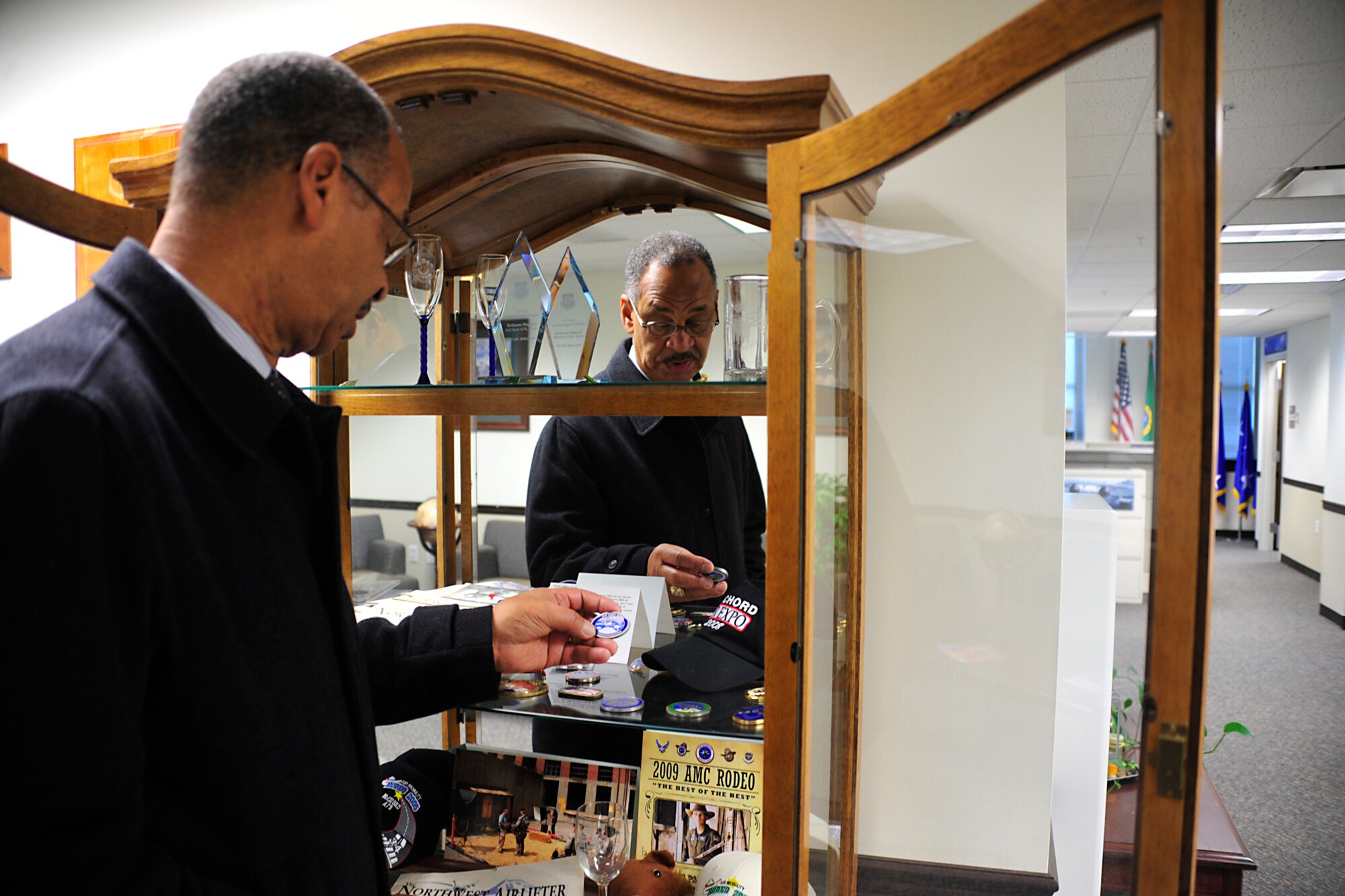 Jonathan Harris looks through Air Mobility Command Rodeo coins and memorabilia as he discusses his career Nov. 29 at McChord Field, Joint Base Lewis-McChord, Wash. (U.S. Air Force photo/Adamarie Lewis-Page)