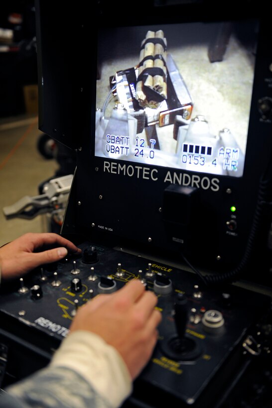 ELLSWORTH AIR FORCE BASE, S.D. -- Senior Airman Timothy Hoffpauir, 28th Civil Engineer Squadron explosive ordnance disposal technician, controls a Remotec ANDROS F6A bomb disposal robot using a remote control switch during a training scenario.  The F6A allows the operator to see and control the robot from up to 1,250 feet away. (U.S. Air Force photo/Staff Sgt. Marc I. Lane)