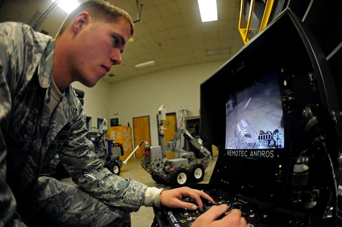 ELLSWORTH AIR FORCE BASE, S.D. -- Senior Airman Timothy Hoffpauir, 28th Civil Engineer Squadron explosive ordnance disposal technician, controls a Remotec ANDROS F6A bomb disposal robot using a remote control switch.  The F6A can be operated up to 1,250 feet away from the control unit, which helps protect EOD technicians from possibly being injured by explosions. (U.S. Air Force photo/Staff Sgt. Marc I. Lane)