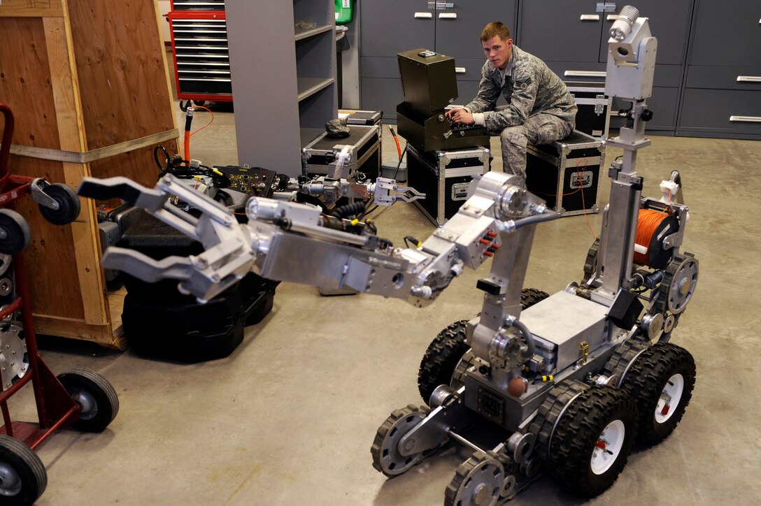 ELLSWORTH AIR FORCE BASE, S.D. -- Senior Airman Timothy Hoffpauir, 28th Civil Engineer Squadron explosive ordnance disposal technician, performs an operational check of a Remotec ANDROS F6A bomb disposal robot.  The F6A is equipped with articulating tracks for navigating ditches, obstacles, stairs and uneven terrain. (U.S. Air Force photo/Staff Sgt. Marc I. Lane)