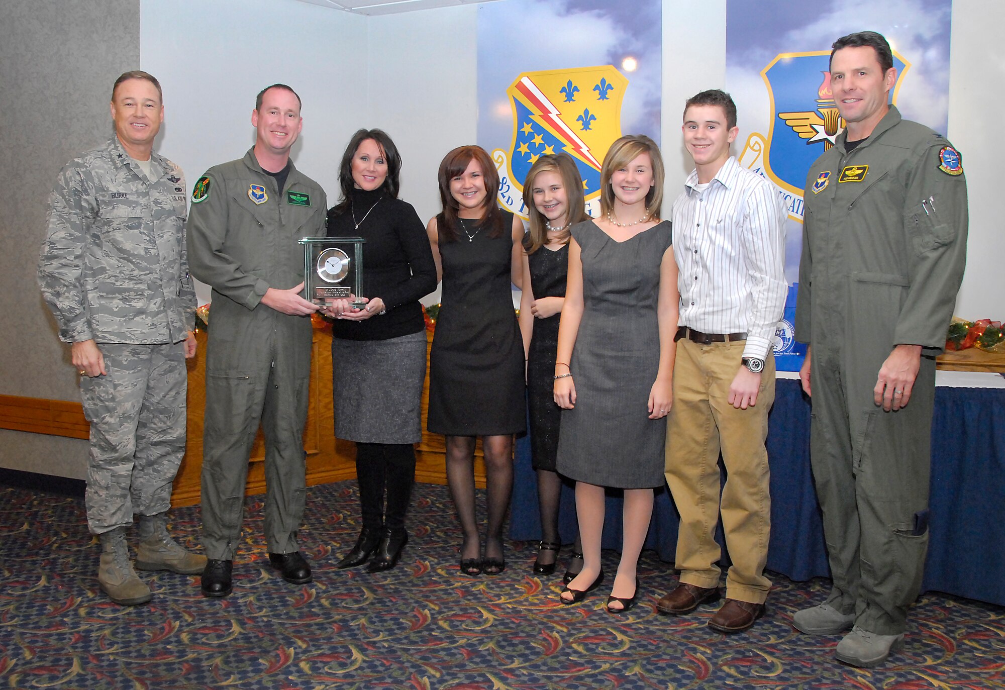 Maj. Kenneth Cook, an instructor pilot at the 459th Flying Training Squadron, and his family receive the Military Family of the Year 2010 award from Brig. Gen. Darryl Burke, 82nd Training Wing commander, and Col. George Menker, 80th Flying Training Wing vice commander Dec. 1 during the Military Family of the Year Social at the Sheppard Club. Pictured from left to right are General Burke, Major Cook, his wife Lindy, their four children McKell, Kenzie, Shelby and Nicholas and Col. Menker. (U.S. Air Force photo/ Harry Tonemah)