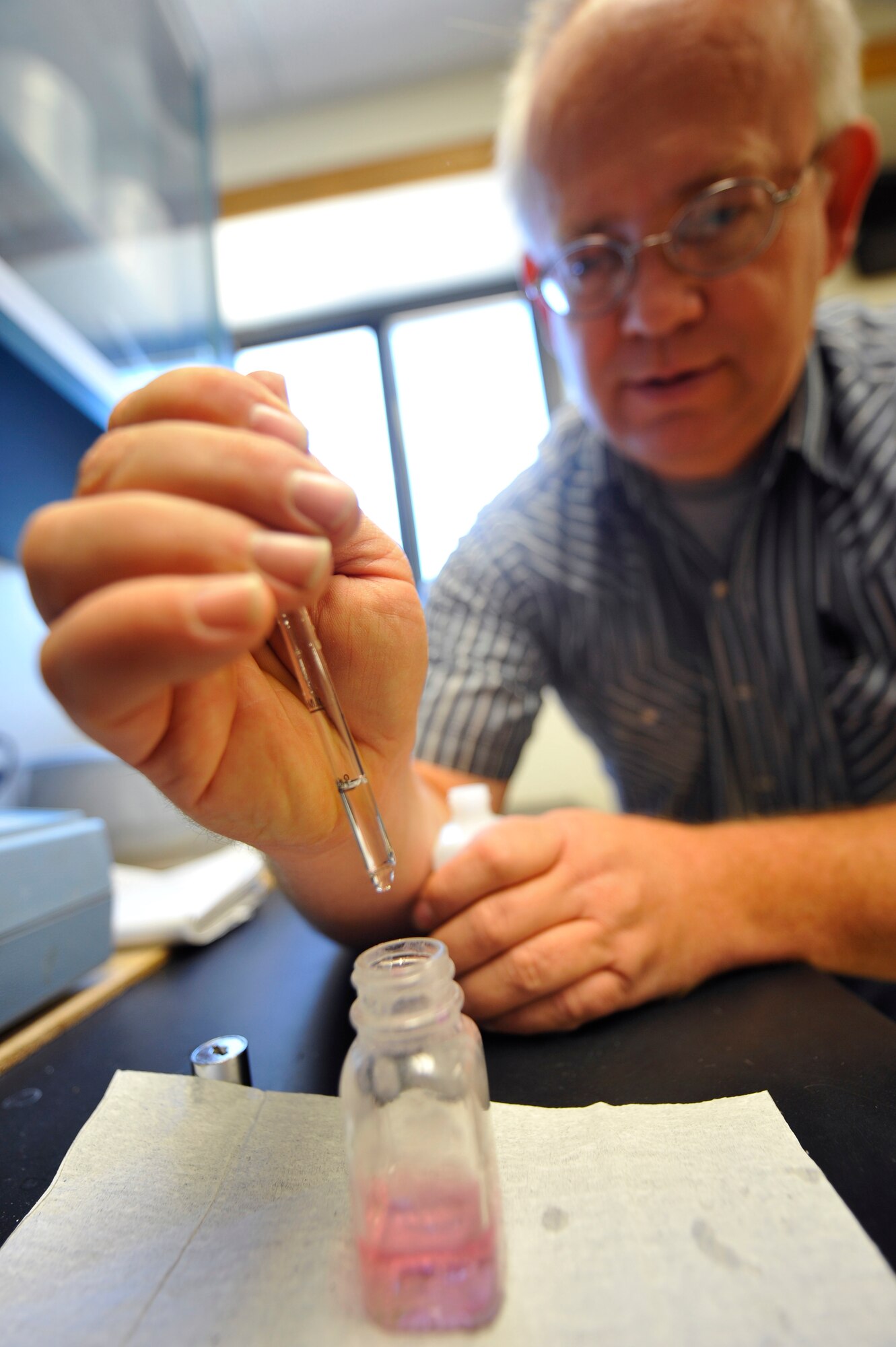 HOLLOMAN AIR FORCE BASE, N.M. -- Mark Stevenson, a water plant operator for the 49th Civil Engineer Squadron, counts the drops of titrant solution needed to identify the intensity of calcium present in Holloman's potable water during a test Nov. 30, 2010. He and other water plant operators test the potable water daily to measure the calcium and chlorine levels to insure it is adequately disinfected. Although the water is purified in Alamogordo, members from the 49th CES constantly perform checks to make sure it is always drinkable. (U.S. Air Force photo by Senior Airman Veronica Stamps/Released)
