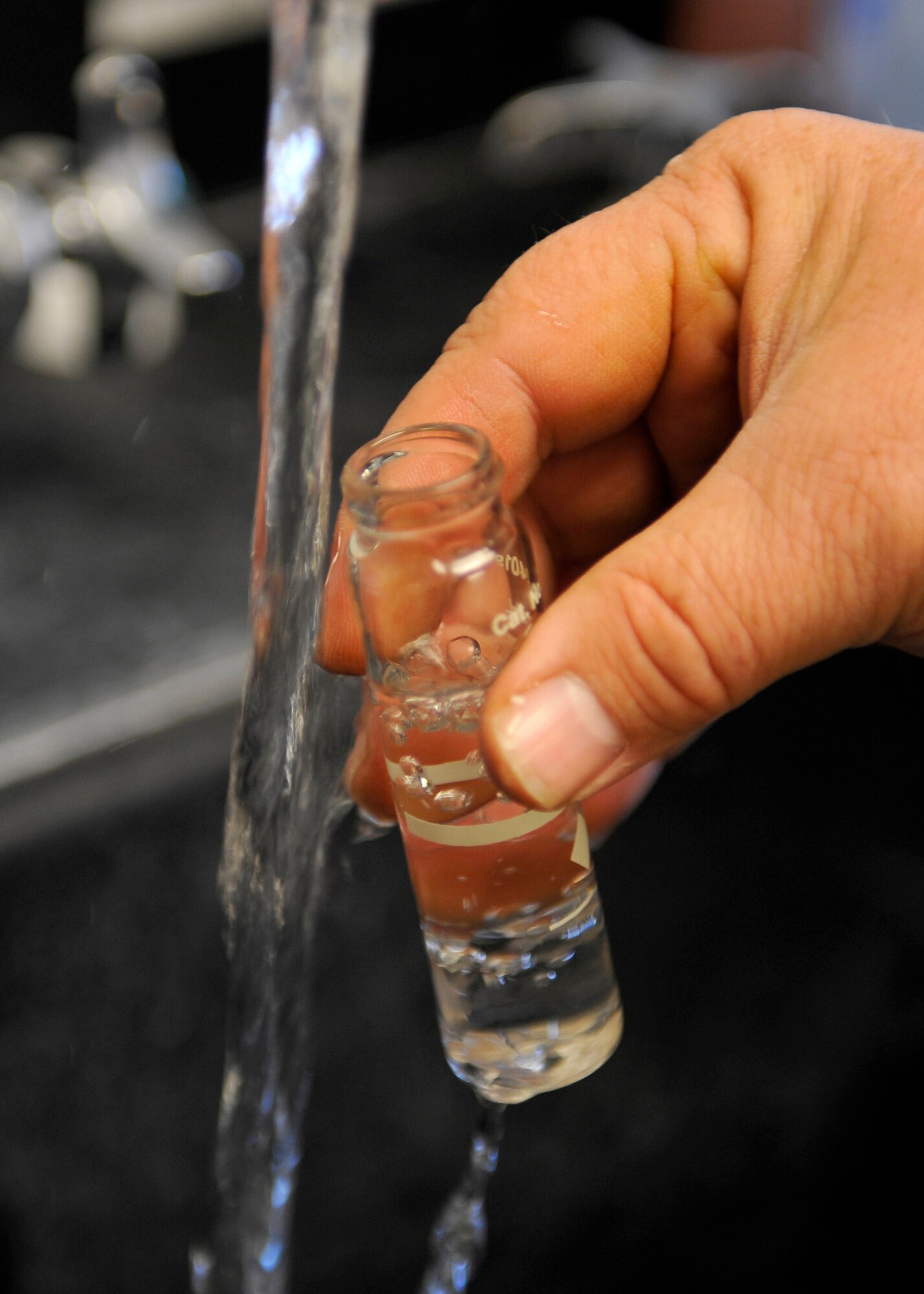 HOLLOMAN AIR FORCE BASE, N.M. -- Mark Stevenson, a water plant operator with the 49th Civil Engineer Squadron, fills a beaker with tap water to perform a chemical test to check Holloman's water quality Nov. 30, 2010. He and other operators test the quality of the potable water daily. Members of the 49th CES perform inspections of the water towers and tanks to ensure they are functioning properly, and also maintain the wells located off base that provide water to Holloman. (U.S. Air Force photo by Senior Airman Veronica Stamps/Released) 