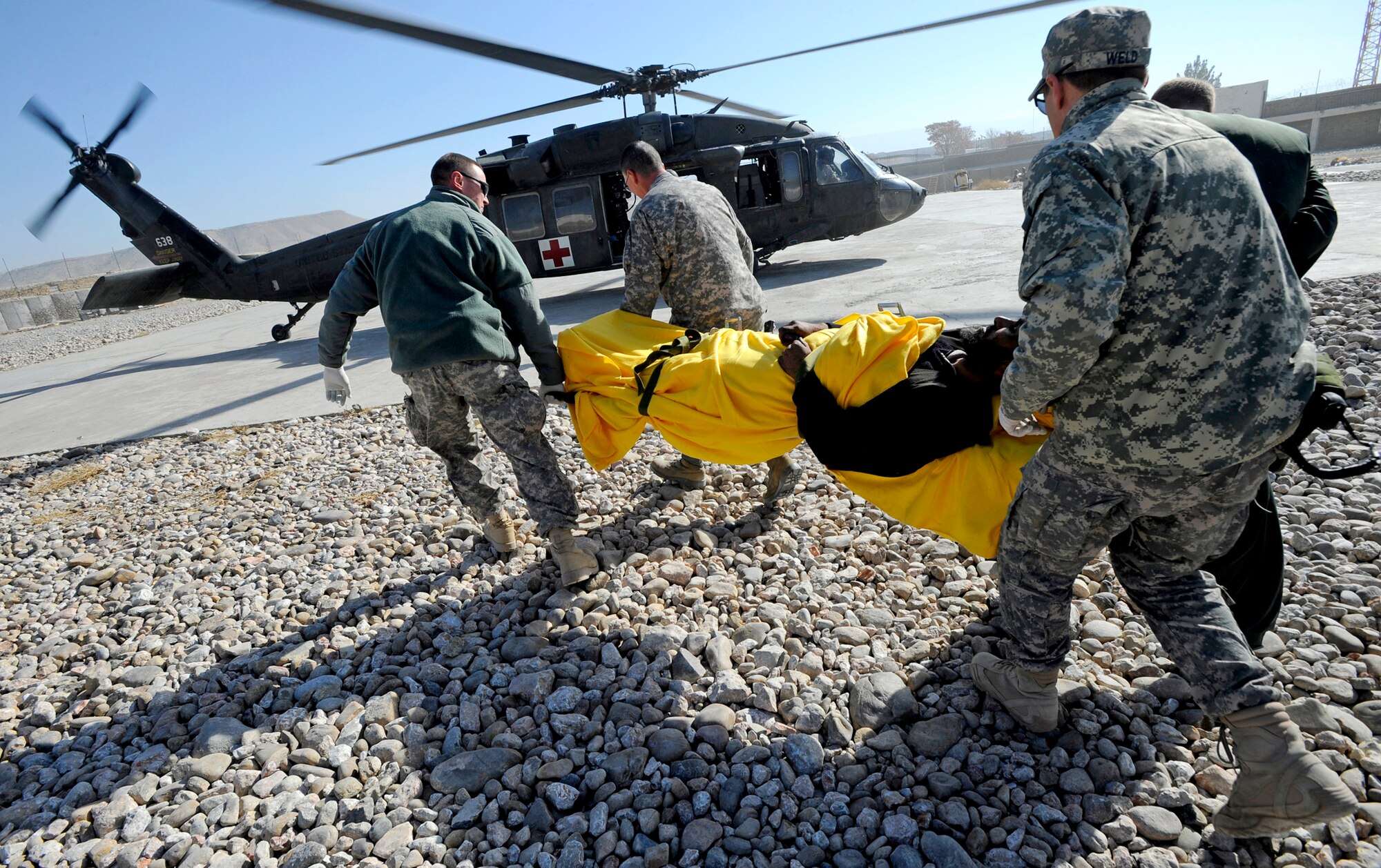 Airmen and Soldiers from the Provincial Reconstruction Team Zabul load a patient onto a medevac helicopter after a civilian bus rolled over, leaving seven dead and more than 30 injured just outside Qalat City, Afghanistan, Nov. 30, 2010. Medical personnel from the PRT were on the scene at a local hospital to assess patients and provide medical care. (U.S. Air Force photo/Staff Sgt. Brian Ferguson)
