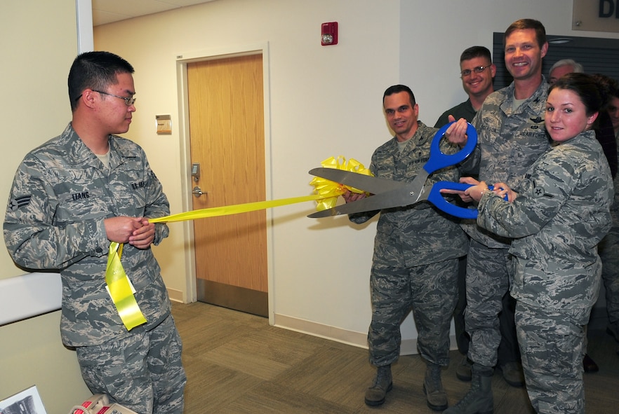 MOODY AIR FORCE BASE, Ga.-- Col. Gary Henderson, 23rd Wing commander, and Airman Lee Sandebeck, 23rd Aerospace Medicine Squadron, prepare to cut the ribbon during the dental clinic expansion opening Dec. 3. The dental expansion will offer approximately 3,000 more appointments each year and reduces the waiting time. (U.S. Air Force photo/Senior Airman Stephanie Mancha)(RELEASED)