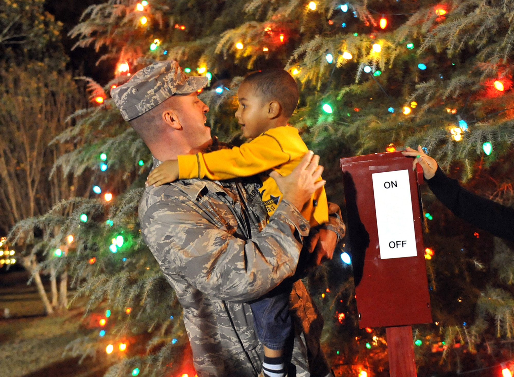 3-year old Josiah Hawkins helps Col. Carl Buhler, 78th Air Base Wing commander, light the chapel Christmas tree. Team Robins conducted its annual Christmas Tree and Menorah Lighting Ceremony Tuesday. The event featured musical selections from the Veterans High School and Matt Arthur Elementary School choruses, a guest appearance by Santa Claus, and the reading of "T'Was the Night Before Christmas". U. S. Air Force photo by Tommie Horton