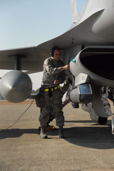 U.S. Air Force Airman 1st Class Daniel Babis, a weapons load crew member from the 35th Aircraft Maintenance Squadron, secures an F-16 Fighting Falcon after the aircraft landed at the Komatsu Air Base, Japan, runway on Dec. 1, 2011. Twelve F-16s from Misawa arrived at Komatsu AB Dec. 1 in support of the Japan-wide, week-long Keen Sword exercise, Dec. 3 to 10. (U.S. Air Force photo by 1st Lt. Cammie Quinn)