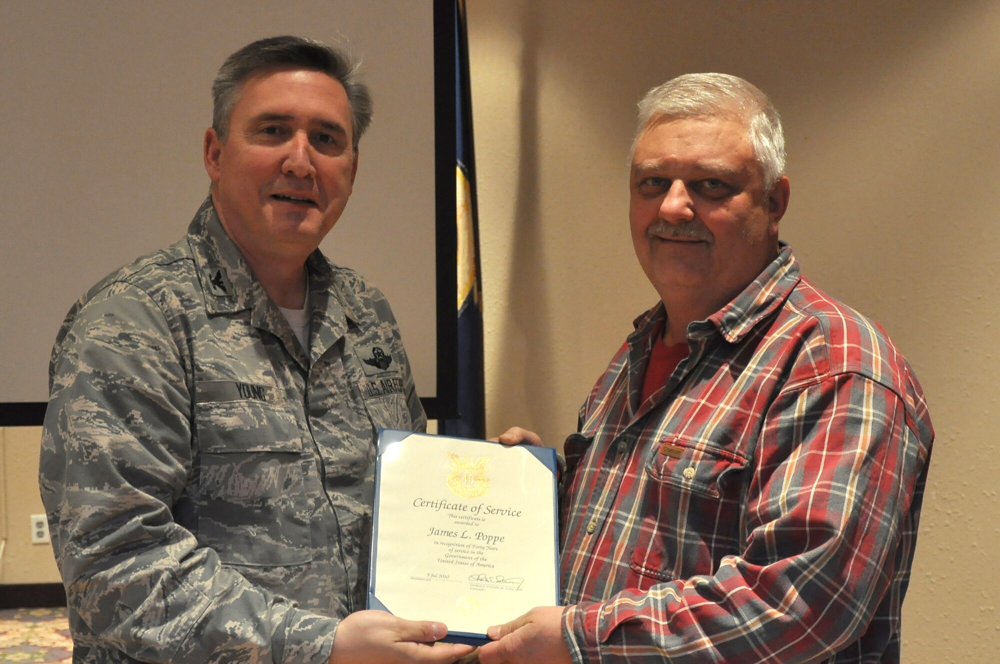 Colonol Darrell Young, 934th Airlift Wing Commander  presents 40 Service award to James Poppe (Air Force Photo/TSgt Bob 