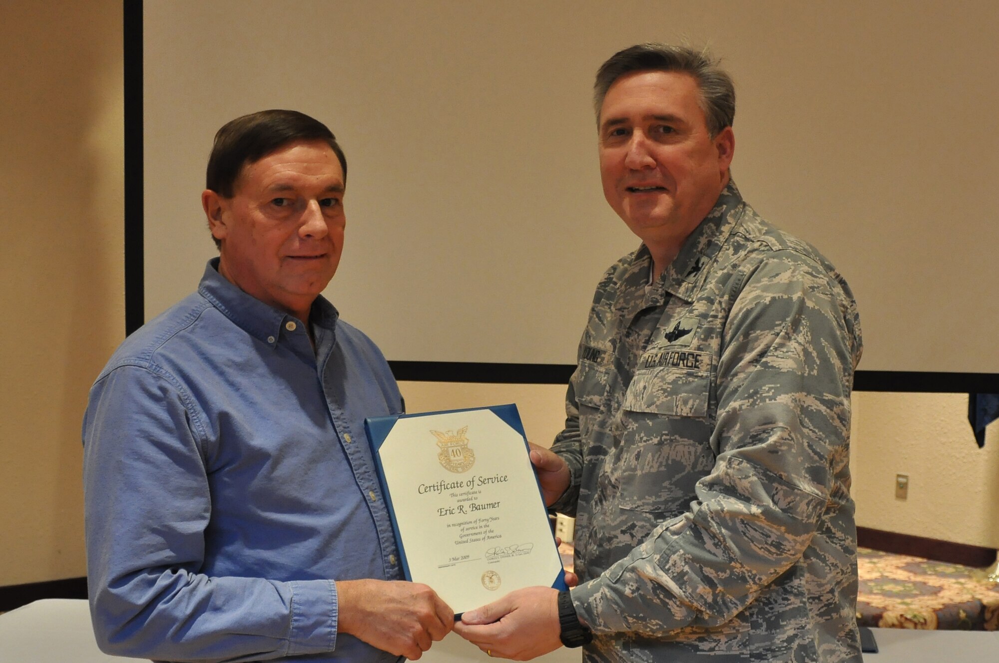 Colonol Darrell Young, 934th Airlift Wing Commander  presents 40 Service award to Eric Baumer (Air Force Photo/TSgt Bob 