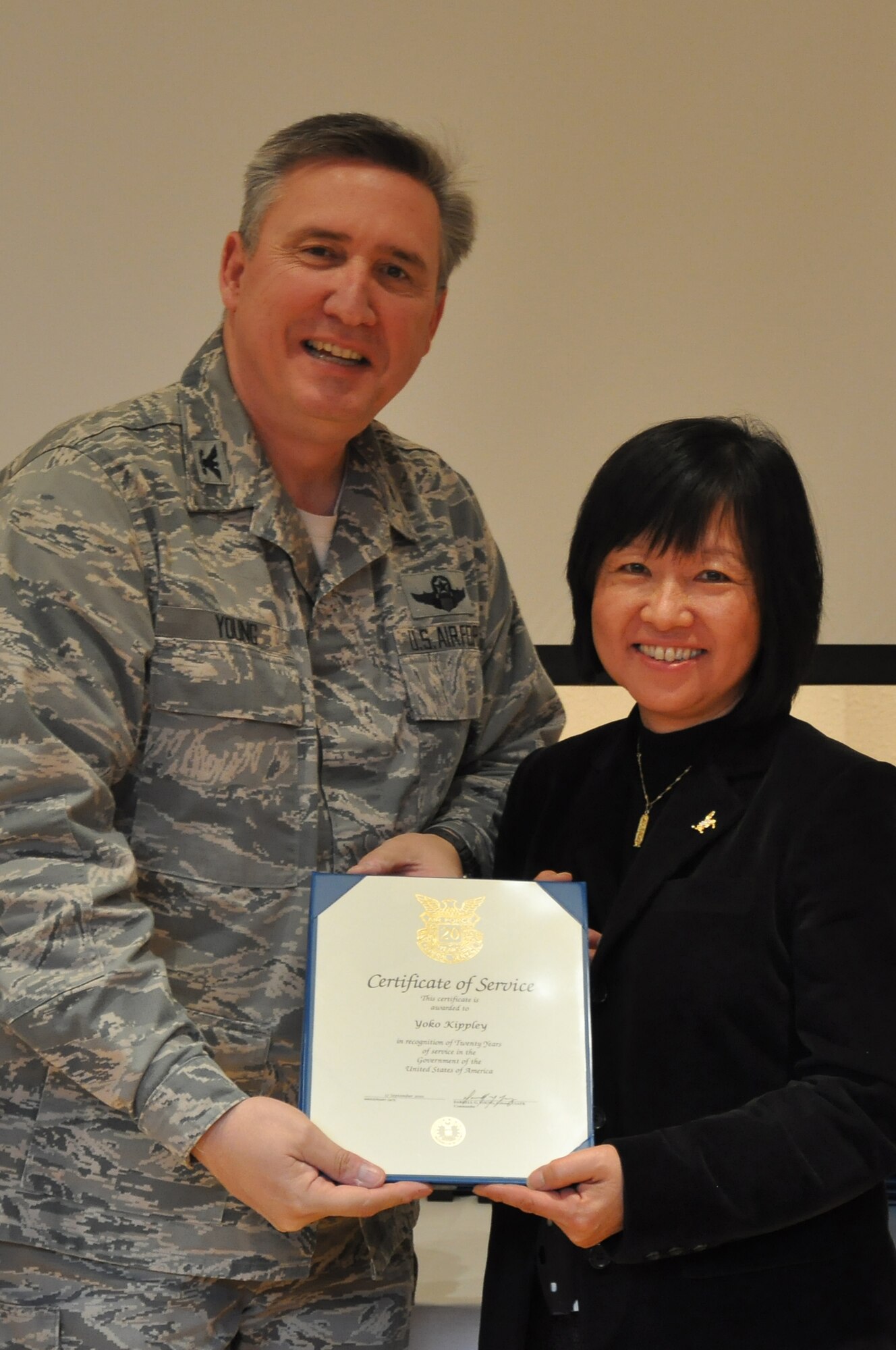 Colonol Darrell Young, 934th Airlift Wing Commander  presents 20 Service award to Yoko Kippley (Air Force Photo/TSgt Bob 