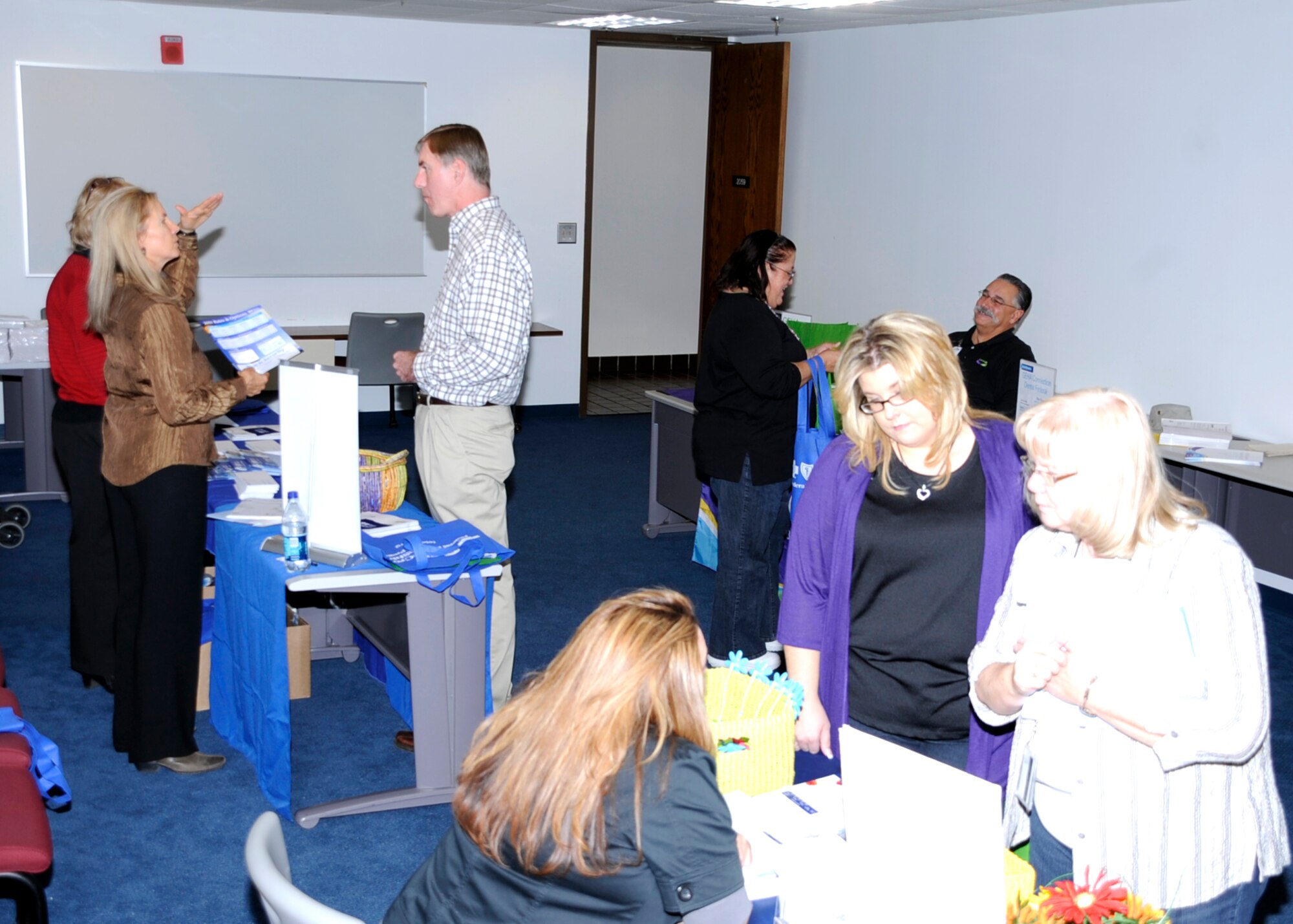 Civilian employees at Cannon Air Force Base, N.M., get their health questions answered by area health benefit  specialists Dec. 2 at the Open Season Health Fair. Federal workers can make changes to their health insurance plans until Dec. 13, and the changes take effect Jan. 3, 2011. (Air Force photo by Greg Allen)