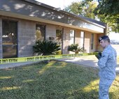 LAUGHLIN AIR FORCE BASE, Texas – Senior Airman Brian Fonseca, 47th Security Forces Squadron, puts crime scene tape around Laughlin’s Airman and Family Readiness Center Dec. 2 after it, along with the base chapel, was vandalized. An investigation into the crimes is underway. (U.S. Air Force photo by Airman 1st Class Blake Mize)  