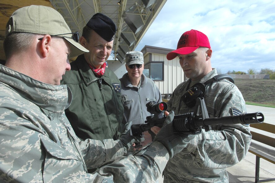 Col. Lynden Skinner (left), and Tech. Sgt. Lee Thompson show Lt. Gen. Paul Fouilland the mechanisms of an M-4 carbine rifle before a test fire Nov. 16, 2010. Colonel Skinner is the Air Force Global Strike Command Security Forces Division chief, Sergeant Thompson is the 2nd Security Forces Squadron armory  NCO in charge and General Fouilland is the French Strategic Air Forces commander-in-chief. (U.S. Air Force photo/Master Sgt. Corey A. Clements) 